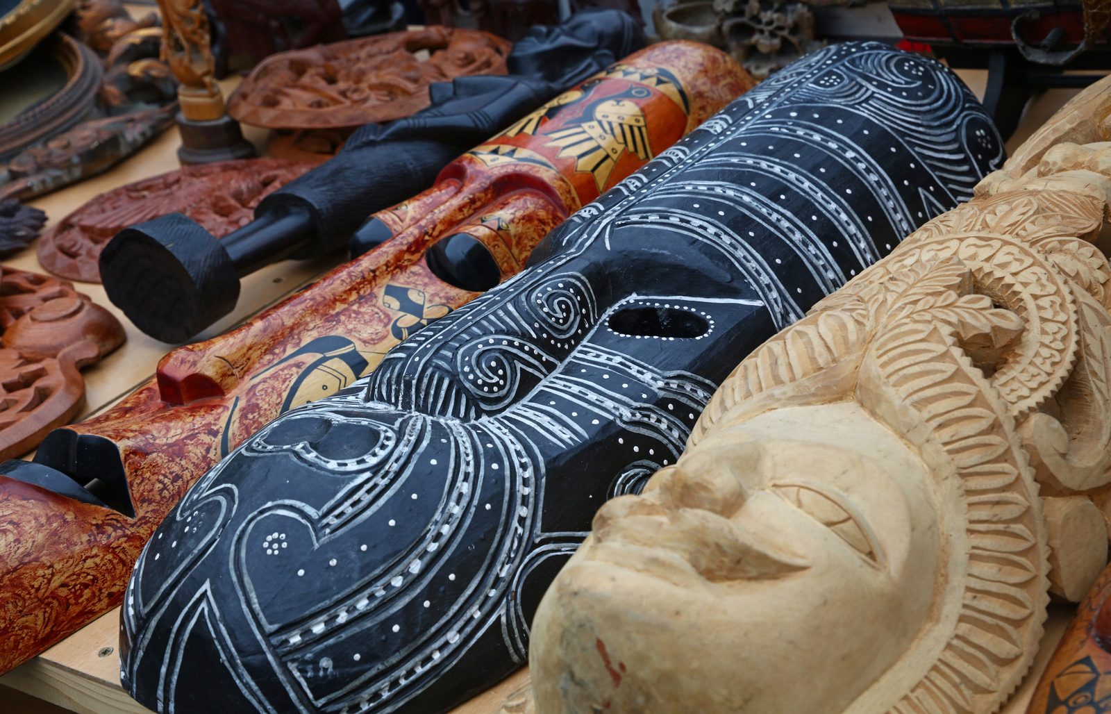 Hand-carved wooden masks at an Indian craft market