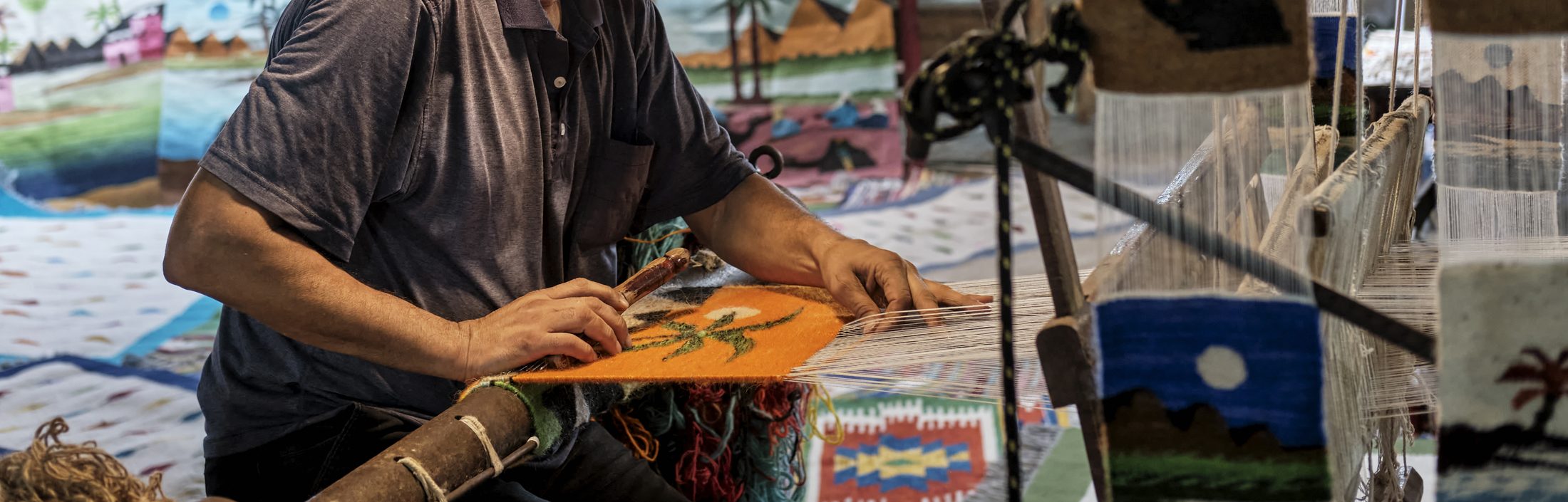 Rug weaver working at a traditional loom